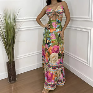 Tropical Print Maxi Dress in blue with a colorful floral design, featuring a sleeveless style and flowing fabric, modeled by a woman.