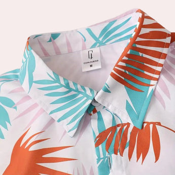 Tropical print men's shirt and shorts set featuring a vibrant leaf pattern, showcasing short sleeves and a collar, perfect for beachwear.