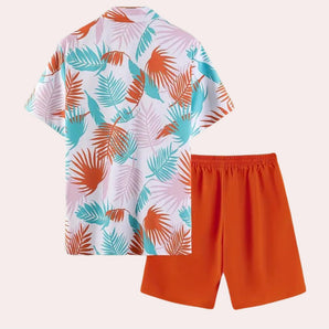 Tropical print men's shirt and shorts set featuring a vibrant leaf pattern, perfect for beachwear. The shirt has a collar and sleeves, complemented by matching shorts. The set is predominantly orange, offering a stylish and summery look.