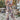 Tropical Print Palm Leaf Sleeveless Jumpsuit in viola, features a vibrant and stylish design with palm leaf patterns, perfect for women's summer beachwear. The jumpsuit is sleeveless, showcasing a fitted waist, and is available in size 2XL. The model accessorizes with eyewear, complementing the fashion-forward look.