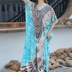 A turquoise boho maxi kaftan with an exotic print, perfect as a lightweight beach cover-up or summer dress.