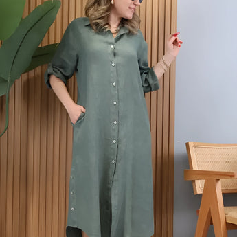 Turquoise linen dress with an asymmetrical hem and long sleeves, featuring a stylish summer design. The dress includes a defined waist and a collar, highlighting its one-piece garment structure.