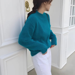 Turquoise plush crewneck sweater with a cozy soft-touch fabric, featuring long sleeves and a relaxed fit, displayed in a teal color, one size.