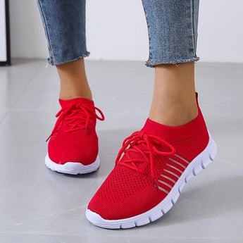 Turquoise women's breathable mesh sneakers, lightweight running shoes, displayed in red color, size 44, shown on a person's feet standing on a grey surface.
