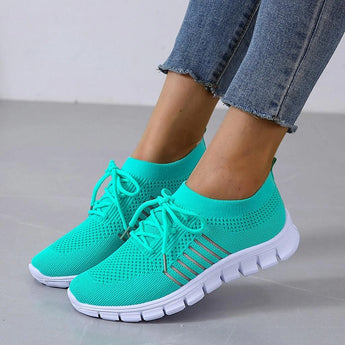 Turquoise women's breathable mesh sneakers for running, displayed on a white background, highlighting the lightweight design and turquoise color in size 44.