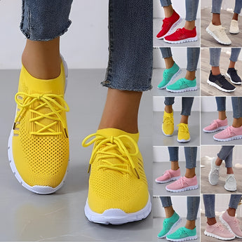 Turquoise women's breathable mesh sneakers, lightweight running shoes, shown on a person wearing white leggings.