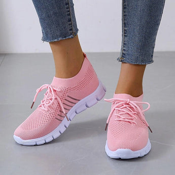 Turquoise women's breathable mesh sneakers shown on a person's feet, highlighting the lightweight and comfortable design suitable for running.