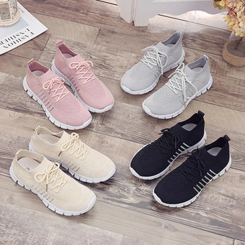 Turquoise women's breathable mesh sneakers, lightweight running shoes, with white and grey accents, designed for outdoor activities, shown on a flooring background.