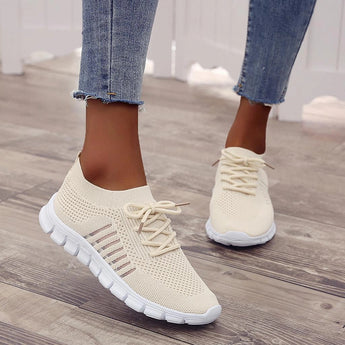 Turquoise Women's Breathable Mesh Sneakers in Beige, size 44, shown on a person's feet standing. The lightweight running shoes feature a mesh textile for breathability.
