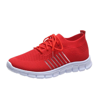 Turquoise women's breathable mesh sneakers for running, shown on grass.