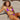 Woman wearing a two-tone blue and black string bikini, showcasing adjustable luxury beachwear with a focus on the swimsuit top and bottom.