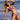 Woman wearing luxury two-tone blue and black string bikini on the beach, showcasing adjustable swimsuit top and bottom.