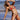 Woman wearing a two-tone blue and black string bikini on the beach, showcasing the adjustable swimsuit top and bottom.