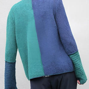 Handmade wool sweater in a two-tone design featuring green and blue colors. The unisex eco-friendly knit sweater displays a stylish pattern with emphasis on the shoulder and neck areas, highlighting its outerwear attributes.