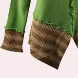 Asymmetrical ruffled sweater in a two-tone green and brown design, featuring long sleeves and a toggle closure, crafted from a woolen, woven fabric.