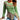 Asymmetrical ruffled sweater in two-tone green and brown, featuring a toggle detail, with long sleeves and a distinctive collar, shown in size XL.
