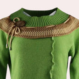 Two-tone green and brown asymmetrical ruffled sweater with a toggle design, featuring long sleeves and a unique collar, modeled with blue jeans.