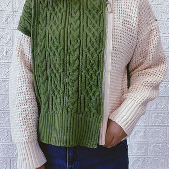 Two-tone women's chunky knit bomber jacket featuring a stylish winter design. The jacket is shown in a neutral grey color, highlighting its textured knit fabric with a focus on the shoulder, collar, and sleeve detailing. The outerwear provides a cozy fit with a defined waist, perfect for winter fashion.