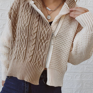 Two-tone women's chunky knit bomber jacket featuring a beige and grey color scheme, with long sleeves, a collar, and a waist-length fit, perfect for winter fashion.