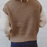 A two-tone chunky knit bomber jacket designed for women, featuring a grey and contrasting color scheme, with a textured outerwear style perfect for winter fashion. The jacket has a prominent shoulder design, a comfortable neckline, long sleeves, and a waist-length fit, modeled in a standing pose showcasing the garment's structure and trendy appeal.