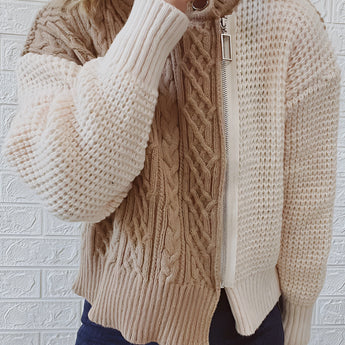 Two-tone chunky knit bomber jacket for women featuring a stylish winter design with a blend of grey hues. The jacket showcases a comfortable fit with long sleeves, a prominent neckline, and a cozy texture suitable for cold weather fashion.