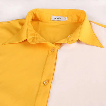 Mid-length sleeveless dress in yellow and white with a belted waist, styled for spring fashion.