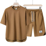 Unisex beige loungewear set in size 3XL, featuring a comfortable and lightweight design ideal for summer. The outfit includes an active shirt with short sleeves and a matching pair of active shorts.