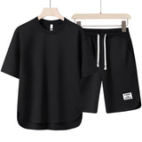 Unisex black loungewear set in size 3XL, featuring a lightweight and comfortable design suitable for summer. The set includes a short-sleeved top with a collar and matching shorts, perfect for casual wear.