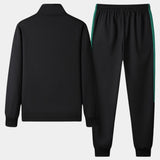 Unisex black turtleneck tracksuit set featuring a sleek design with green stripe joggers, showcasing a comfortable and stylish sportswear look.
