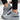 Unisex grey suede low-top sneakers displayed on a neutral background, showcasing their stylish and urban design, featuring light grey tones and black detailing.