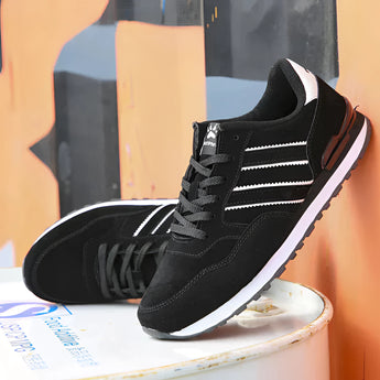 Unisex grey suede low-top sneakers with a stylish urban design, featuring a composite material and electric blue accents, suitable for casual wear and outdoor activities.