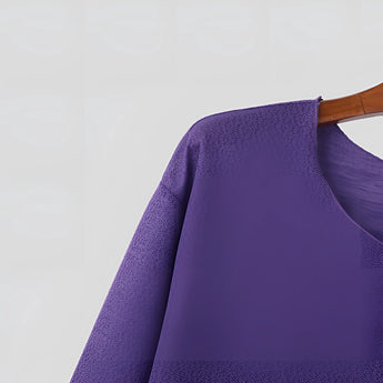 
Image of a unisex lightweight long-sleeve crewneck white t-shirt displayed on a mannequin or hanger, highlighting its simple and classic design with a focus on the neckline and sleeves.