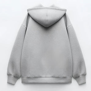 Unisex oversized gray hoodie with a relaxed fit, featuring a comfortable collar and long sleeves, showcasing urban street style fashion.