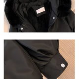 Black urban style jacket featuring silver zippers, adjustable waist, long sleeves, and a collar, displayed against a grey background.