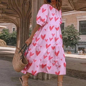 Pink heart print casual midi dress for women, featuring long sleeves, a fitted waist, and a round neckline.