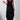 A woman wearing a versatile sleeveless maxi dress with pockets, ideal for summer casual beachwear. The dress highlights her shoulders and legs, with a comfortable waist fit and flowing one-piece garment design.