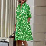 Vibrant asymmetric fuchsia and orange color block dress with green accents, featuring long sleeves, a defined waist, and a stylish collar, modeled in a standing position, in size 4XL.