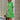 Vibrant asymmetric fuchsia and orange color block dress with green accents, featuring long sleeves, a defined waist, and a stylish collar, modeled in a standing position, in size 4XL.