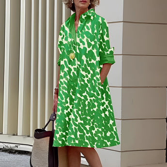 Vibrant asymmetric fuchsia and orange color block dress with green accents, featuring long sleeves, a defined waist, and a stylish collar, modeled in a standing position, in size 4XL.