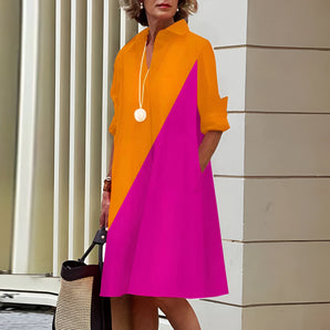 Vibrant asymmetric fuchsia and orange color block dress in pink-orange color, featuring a knee-length design with a defined waist, short sleeves, and a stylish neckline. Ideal for fashion-forward occasions, available in size 4XL.
