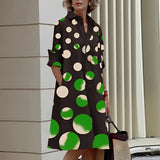 Vibrant asymmetric dress with fuchsia and orange color block design, featuring green polka dot pattern, long sleeves, and a flattering waistline; suitable for events and fashionable settings.
