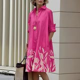 Vibrant asymmetric dress featuring a fuchsia and orange color block design, showcased in a 4XL size. The dress has a stylish shoulder cut, a round neck, and long sleeves, accentuating a cool, fashion-forward look. The predominant color is pink, enhanced with magenta tones.