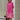 Vibrant asymmetric dress featuring a fuchsia and orange color block design, showcased in a 4XL size. The dress has a stylish shoulder cut, a round neck, and long sleeves, accentuating a cool, fashion-forward look. The predominant color is pink, enhanced with magenta tones.