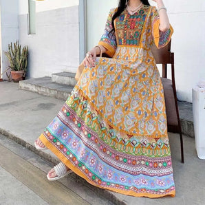 Vibrant yellow ethnic maxi dress featuring intricate floral embroidery and traditional patterns, with long sleeves and a defined waist, styled for a size 2XL.