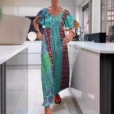 
A woman wearing a Vibrant Ethnic Print Kaftan Dress in Azzurro color, size 3XL, featuring a flowing one-piece design with a loose fit, covering the shoulders and neck. The dress serves as a stylish bohemian beach cover-up, showcasing a colorful ethnic pattern.