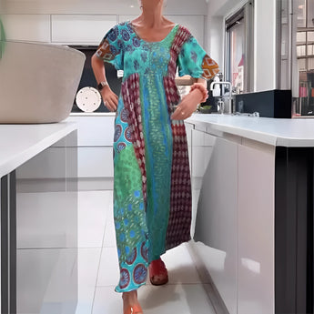 
A woman wearing a Vibrant Ethnic Print Kaftan Dress in Azzurro color, size 3XL, featuring a flowing one-piece design with a loose fit, covering the shoulders and neck. The dress serves as a stylish bohemian beach cover-up, showcasing a colorful ethnic pattern.
