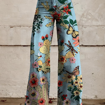 Woman wearing Vibrant Floral Print Bell-Bottom Jeans in Blue Forest color, high-waist, wide-leg denim with a boho style, size 5XL.