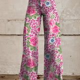 Bohemian high-waist wide-leg denim jeans in a vibrant pink floral print, featuring bell-bottom design, modeled by a person wearing 5XL.