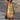 Sleeveless summer dress with a vibrant leaf pattern in yellow, shown in 4XL size, highlighting the shoulders, neck, and waist.