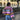 Handmade wool boho chic sweater in vibrant multicolor patchwork, featuring long sleeves and a purple color, size large, displayed outdoors near a building with plants and trees in the background.